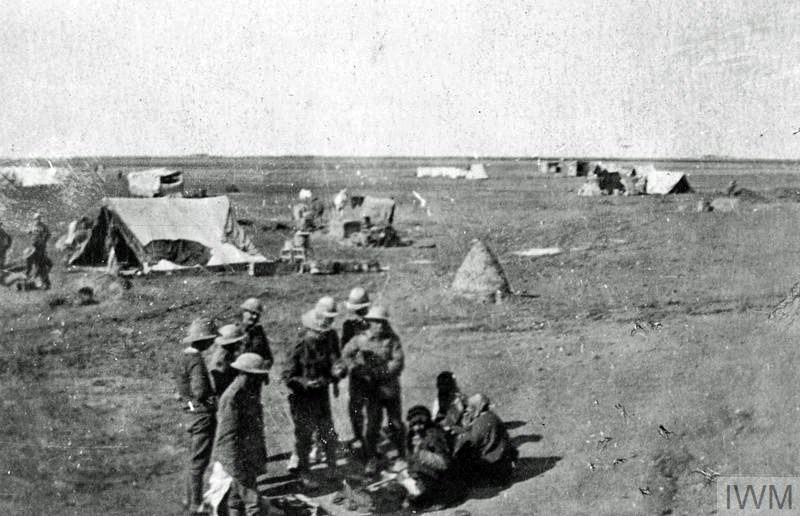 This is thought to be the 9th Battalion of the Royal Warwickshires in Persia in 1918 bartering with local traders near their camp. ©Imperial War Museum (Ref Q73062)