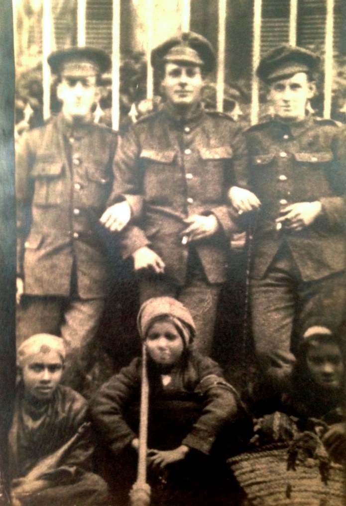 George in India with two comrades in arms and three local boys.