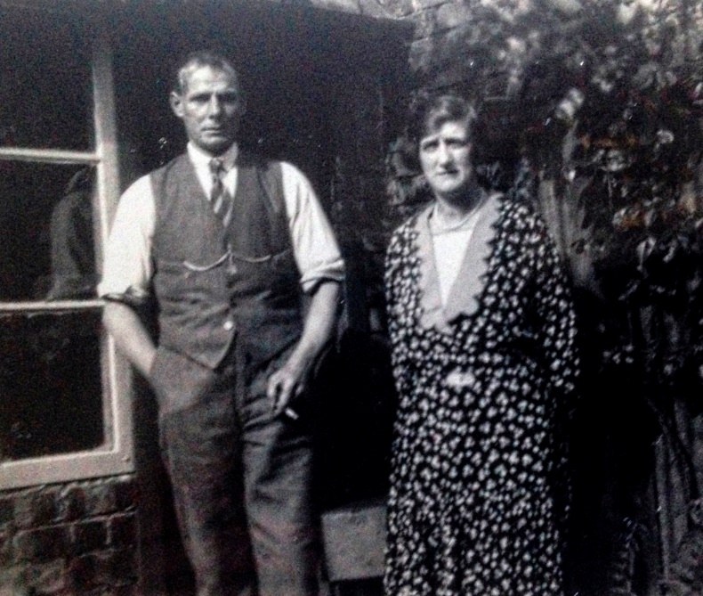 George and Clara outside the shed where he worked. He sold his boots from this shed.