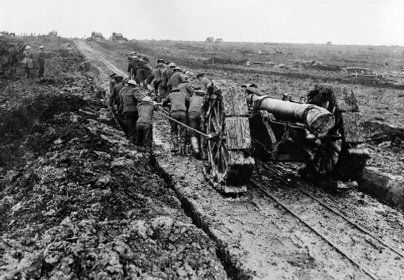 A 6-inch 26 cwt howitzer being manhandled through the mud during the Battle of the Somme 1916. The devices round the wheels to stop sinking were called girdles.