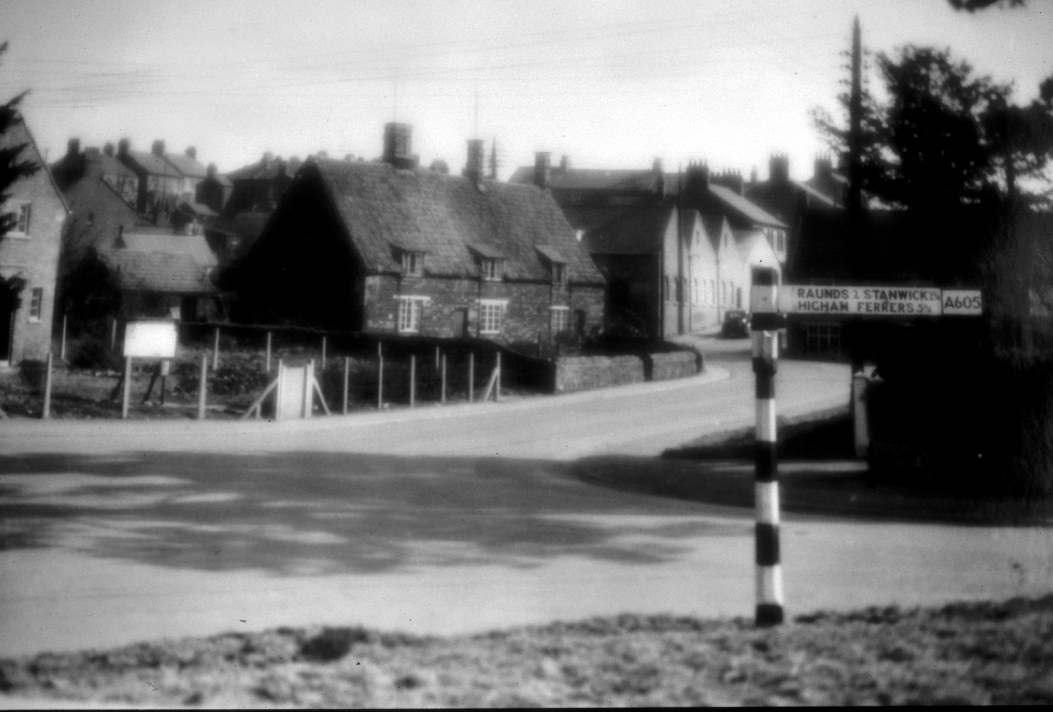 Pearce’s Row was in the narrow lane on the right between the Police House and the old row of cottages. Church Street now ends at the road sign but in the Census continues to the corner.