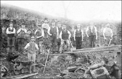 An Ironstone Quarry near Burton Latimer (probably in 1890s). This picture show the planks only a few feet above the ground but there are concrete supports on the extreme right of the picture which probably indicates that the "gullet" becomes deeper. We can also see the mess beneath the planks on which man and barrow might fall. With the kind permission of Burton Latimer Heritage Society ()