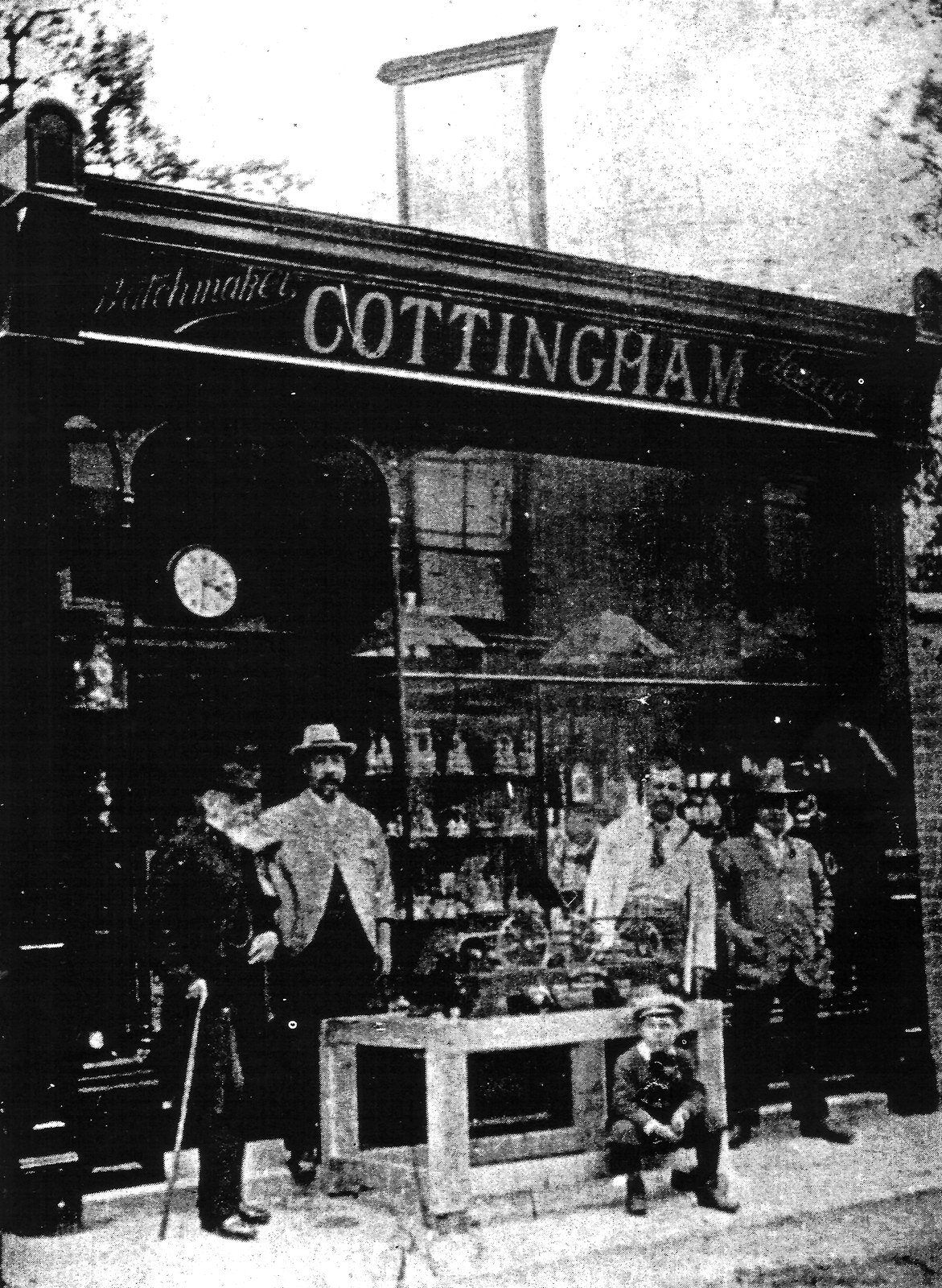 Edwin outside his shop with the clock he designed for Thrapston Church. The Rector is on the left and I believe that Edwin is the man standing next to him (or could he be the man in the white coat?). With the kind permission of the Antiquarian Horological Society.
